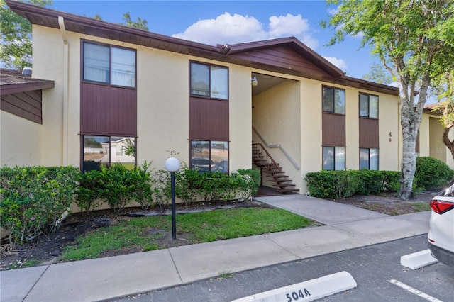504 Silver Crse Unit A, Ocala, FL 34472 - view of building exterior featuring stairs and uncovered parking