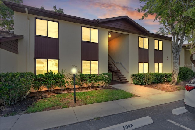 504 Silver Crse Unit A, Ocala, FL 34472 - view of front of home featuring stairway, uncovered parking, and stucco siding