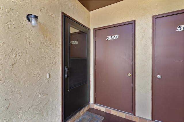 504 Silver Crse Unit A, Ocala, FL 34472 - doorway to property with stucco siding