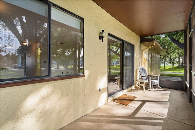 504 Silver Crse Unit A, Ocala, FL 34472 - unfurnished sunroom with a textured wall and concrete flooring