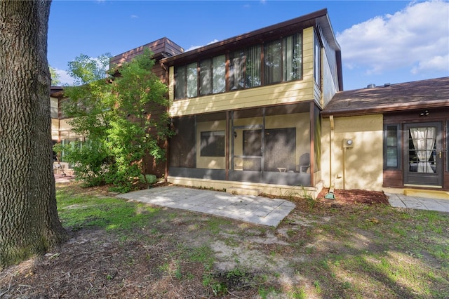 504 Silver Crse Unit A, Ocala, FL 34472 - rear view of house featuring a sunroom and stucco siding