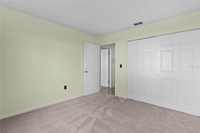 504 Silver Crse Unit A, Ocala, FL 34472 - unfurnished bedroom featuring light colored carpet, baseboards, and a closet