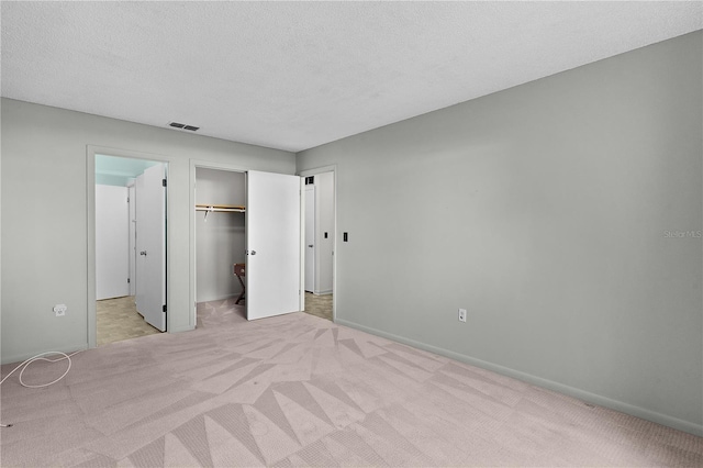 504 Silver Crse Unit A, Ocala, FL 34472 - unfurnished bedroom featuring light carpet, baseboards, a textured ceiling, and a closet