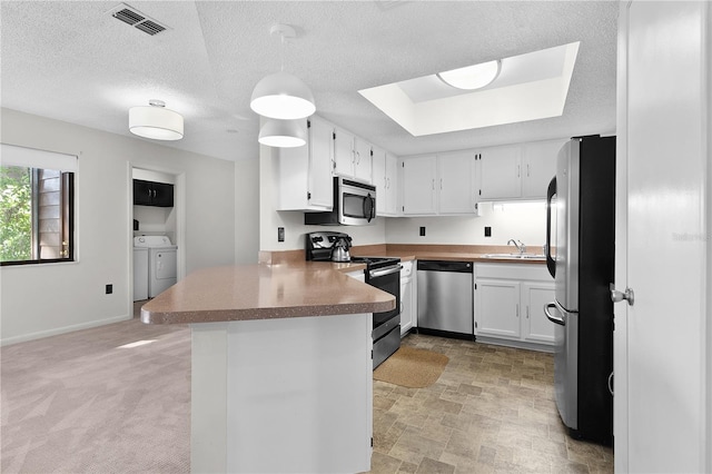 504 Silver Crse Unit A, Ocala, FL 34472 - kitchen featuring stainless steel appliances, independent washer and dryer, a peninsula, a sink, and white cabinets
