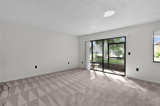 504 Silver Crse Unit A, Ocala, FL 34472 - spare room featuring light carpet, a textured ceiling, and baseboards
