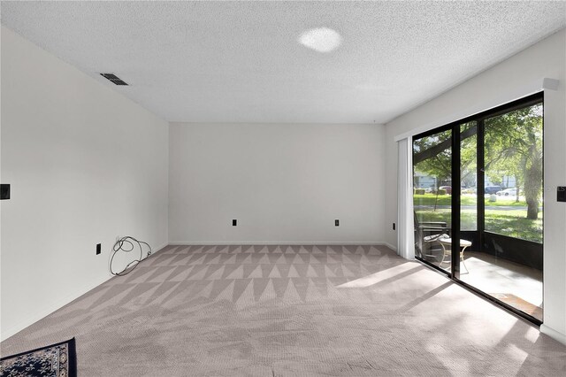 504 Silver Crse Unit A, Ocala, FL 34472 - unfurnished room with light carpet, a textured ceiling, and baseboards