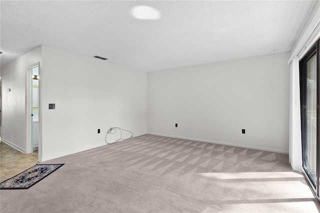 504 Silver Crse Unit A, Ocala, FL 34472 - unfurnished room featuring light carpet, a textured ceiling, and baseboards
