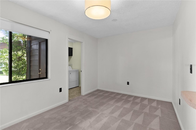 504 Silver Crse Unit A, Ocala, FL 34472 - empty room with washer / dryer, light colored carpet, a textured ceiling, and baseboards
