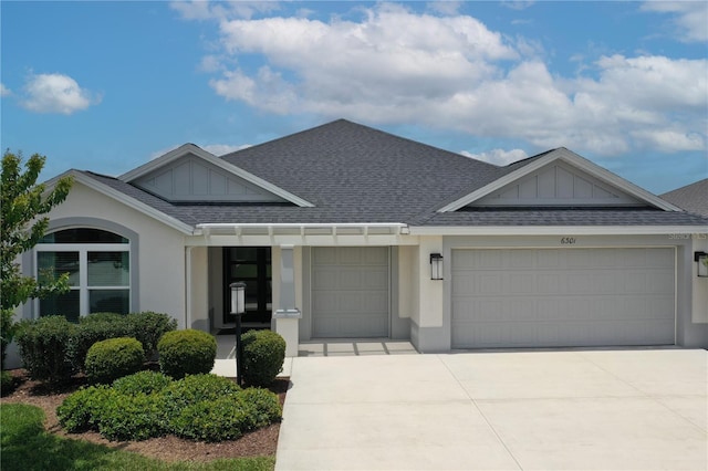 6301 Danielson Loop, The Villages, FL 32163 - view of front facade with a garage, driveway, roof with shingles, and stucco siding