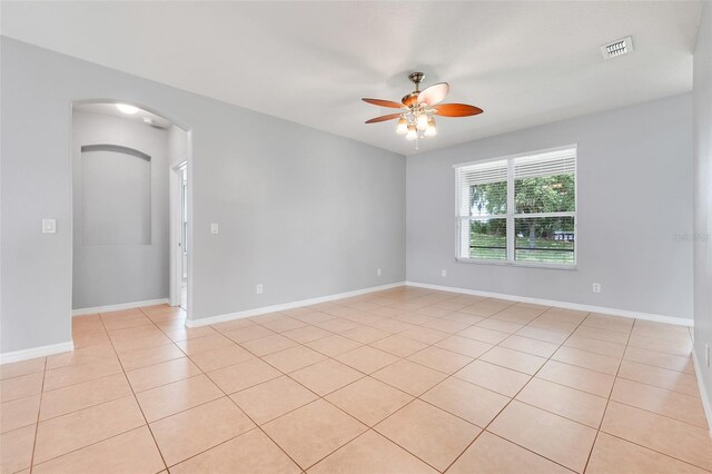 2745 Shearwater St, Clermont, FL 34711 - spare room featuring a ceiling fan, light tile patterned floors, and arched walkways