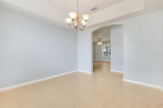 2745 Shearwater St, Clermont, FL 34711 - empty room featuring arched walkways, a chandelier, light tile patterned flooring, and a ceiling fan