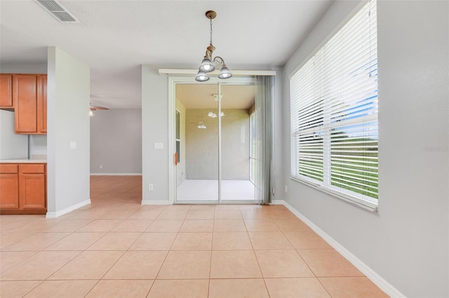 2745 Shearwater St, Clermont, FL 34711 - unfurnished dining area with a chandelier and light tile patterned floors