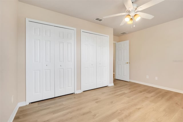 2745 Shearwater St, Clermont, FL 34711 - unfurnished bedroom featuring two closets, light wood finished floors, and ceiling fan