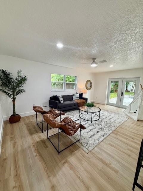8203 Bluestar Cir, Orlando, FL 32819 - living room with plenty of natural light, light wood-type flooring, baseboards, a textured ceiling, and recessed lighting