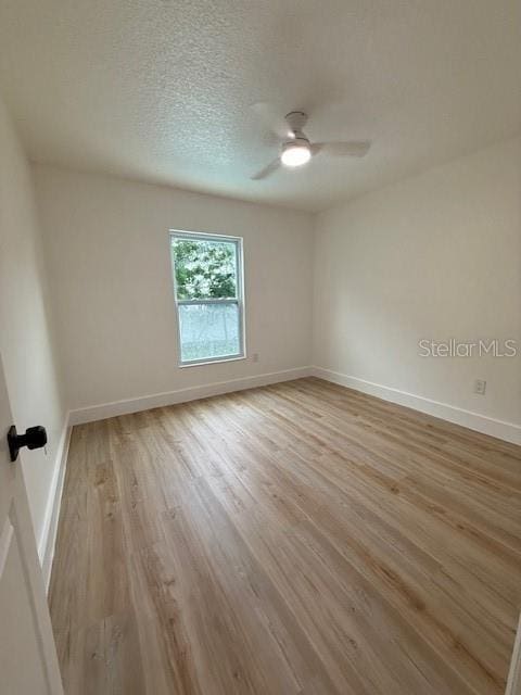 8203 Bluestar Cir, Orlando, FL 32819 - spare room featuring light wood-type flooring, baseboards, and ceiling fan