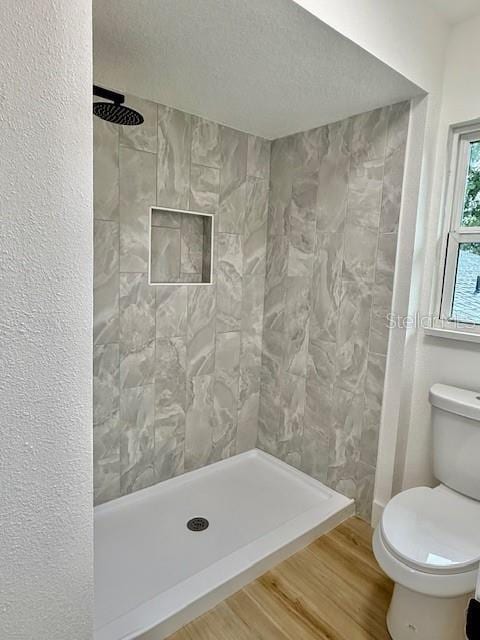 8203 Bluestar Cir, Orlando, FL 32819 - full bathroom with toilet, a shower stall, and wood finished floors
