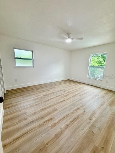 8203 Bluestar Cir, Orlando, FL 32819 - unfurnished room with healthy amount of natural light, baseboards, and light wood-style flooring