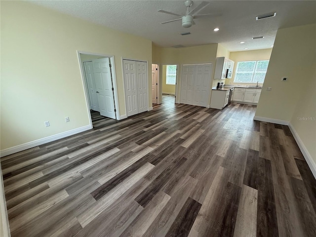 501 N Simpson St, Mount Dora, FL 32757 - unfurnished living room featuring ceiling fan, dark wood-type flooring, recessed lighting, and a textured ceiling
