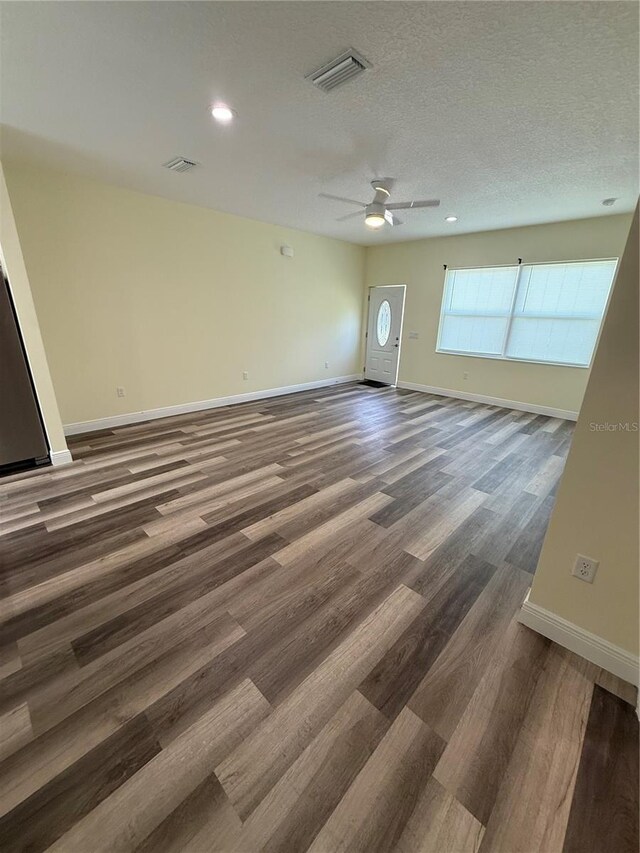 501 N Simpson St, Mount Dora, FL 32757 - unfurnished room featuring wood finished floors, ceiling fan, a textured ceiling, and recessed lighting