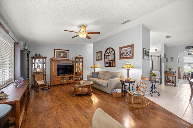 17533 SE 96th Ct, Summerfield, FL 34491 - living room with a ceiling fan, a textured ceiling, arched walkways, and wood finished floors