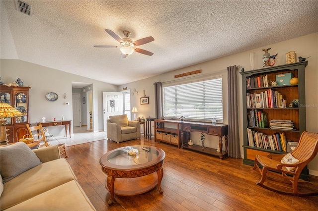 17533 SE 96th Ct, Summerfield, FL 34491 - living room with a ceiling fan, wood-type flooring, a textured ceiling, and vaulted ceiling