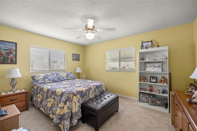 17533 SE 96th Ct, Summerfield, FL 34491 - bedroom with light colored carpet, ceiling fan, and a textured ceiling