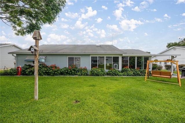 17533 SE 96th Ct, Summerfield, FL 34491 - back of house featuring a lawn and a sunroom