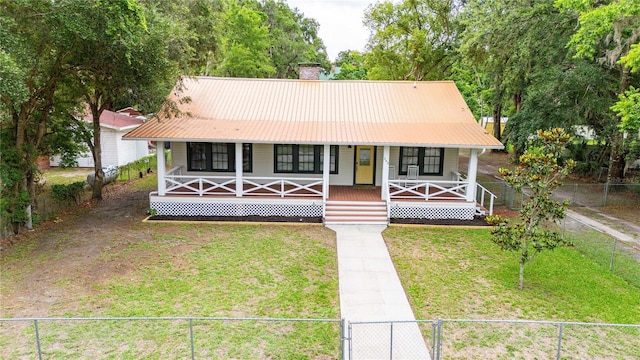 263 NE 1st St, Webster, FL 33597 - view of front of home featuring a porch, a chimney, and metal roof