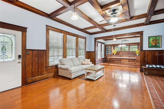 263 NE 1st St, Webster, FL 33597 - living room with wainscoting, hardwood / wood-style floors, beam ceiling, wooden walls, and ceiling fan