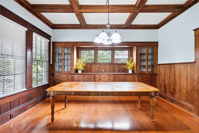 263 NE 1st St, Webster, FL 33597 - dining area with a chandelier, coffered ceiling, hardwood / wood-style flooring, beamed ceiling, and wooden walls