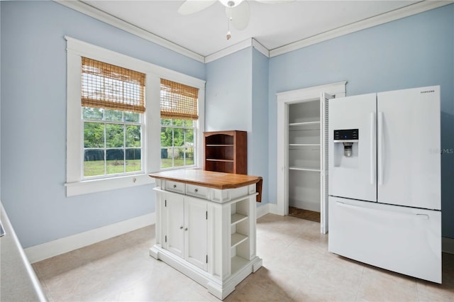 263 NE 1st St, Webster, FL 33597 - kitchen featuring white fridge with ice dispenser, open shelves, ornamental molding, white cabinetry, and a ceiling fan