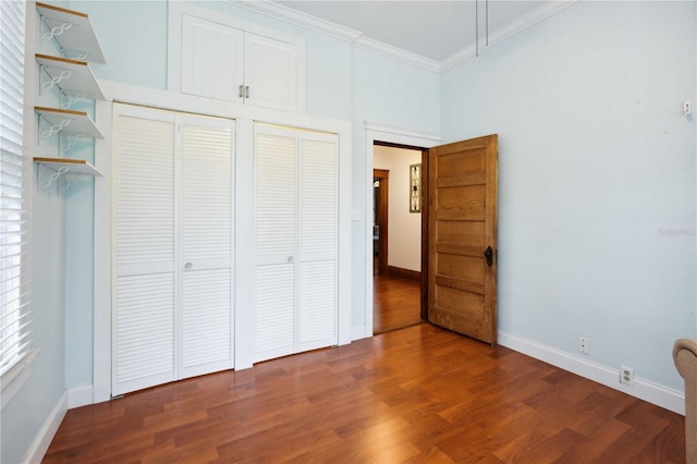 263 NE 1st St, Webster, FL 33597 - unfurnished bedroom with crown molding, baseboards, and wood finished floors
