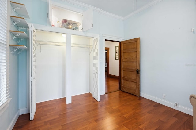 263 NE 1st St, Webster, FL 33597 - unfurnished bedroom featuring crown molding, multiple closets, wood finished floors, and baseboards