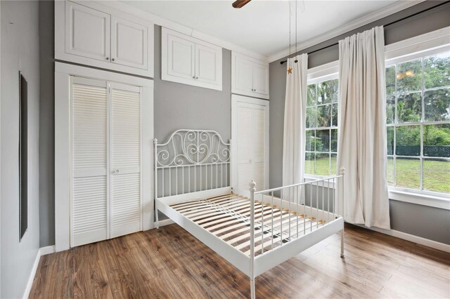 263 NE 1st St, Webster, FL 33597 - bedroom featuring wood finished floors, baseboards, and multiple windows