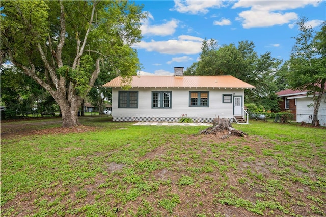 263 NE 1st St, Webster, FL 33597 - view of front facade with entry steps, metal roof, and a chimney
