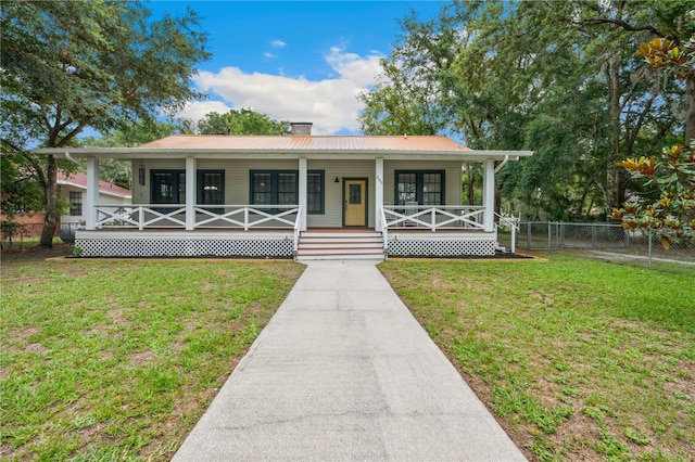 263 NE 1st St, Webster, FL 33597 - view of front of house with a chimney, metal roof, and a porch