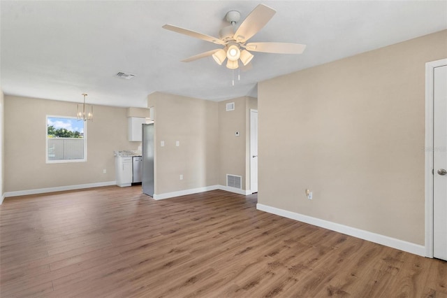 4 Kristin Ln, Eustis, FL 32726 - unfurnished living room with ceiling fan, light wood-style flooring, a chandelier, and baseboards