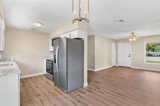 4 Kristin Ln, Eustis, FL 32726 - kitchen featuring stainless steel appliances, light wood finished floors, baseboards, a ceiling fan, and white cabinetry
