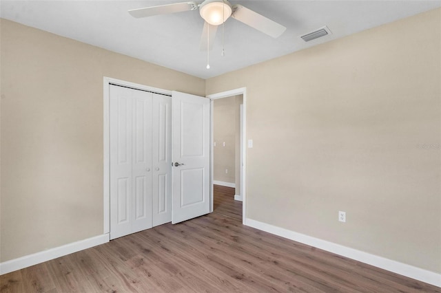 4 Kristin Ln, Eustis, FL 32726 - unfurnished bedroom featuring baseboards, wood finished floors, a closet, and a ceiling fan