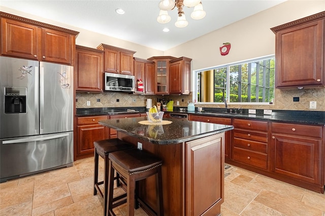 5144 Rishley Run Way, Mount Dora, FL 32757 - kitchen with appliances with stainless steel finishes, a kitchen island, decorative backsplash, glass insert cabinets, and recessed lighting