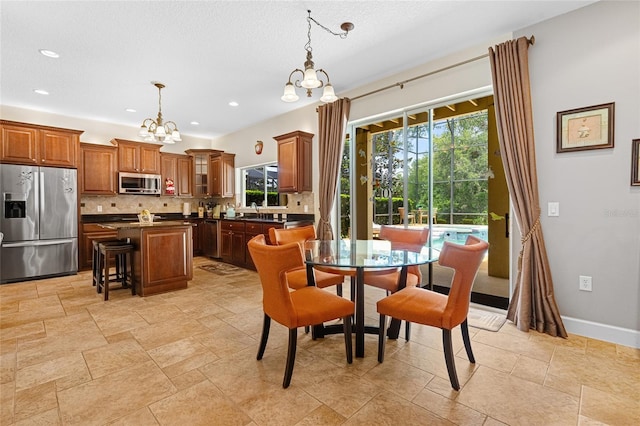5144 Rishley Run Way, Mount Dora, FL 32757 - dining room with a chandelier, recessed lighting, light stone finish flooring, and baseboards