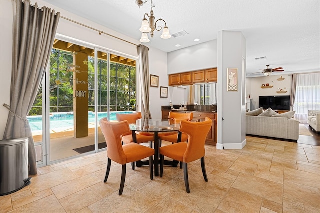 5144 Rishley Run Way, Mount Dora, FL 32757 - dining room featuring stone tile flooring, a ceiling fan, and a chandelier