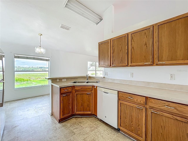 439 Gentle Breeze Dr, Minneola, FL 34715 - kitchen with dishwasher, a sink, brown cabinets, and light countertops