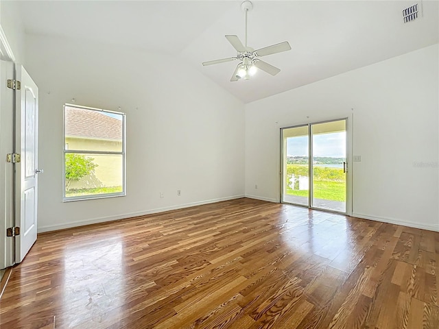 439 Gentle Breeze Dr, Minneola, FL 34715 - empty room with wood finished floors, a ceiling fan, baseboards, and high vaulted ceiling