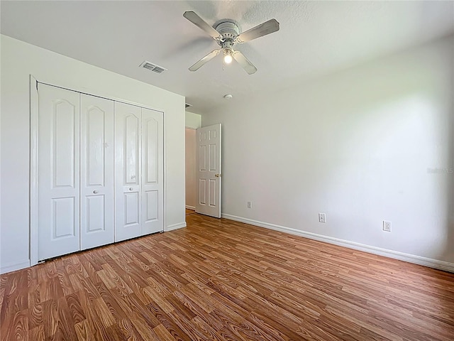 439 Gentle Breeze Dr, Minneola, FL 34715 - unfurnished bedroom featuring wood finished floors, baseboards, a closet, and ceiling fan