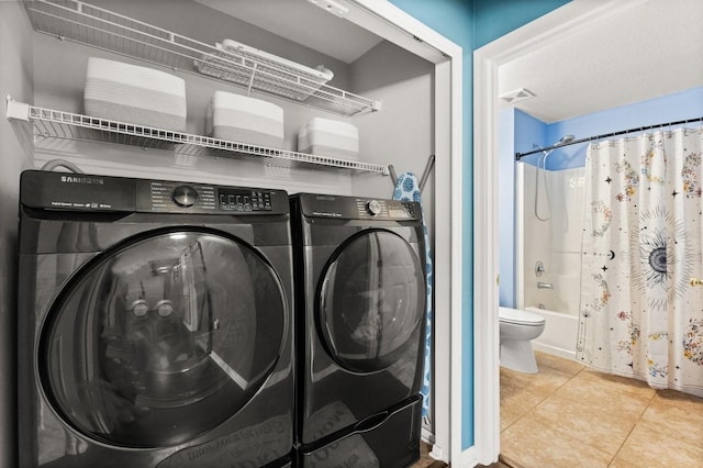 800 Daybreak Dr, Fruitland Park, FL 34731 - laundry room featuring washer and clothes dryer and tile patterned floors
