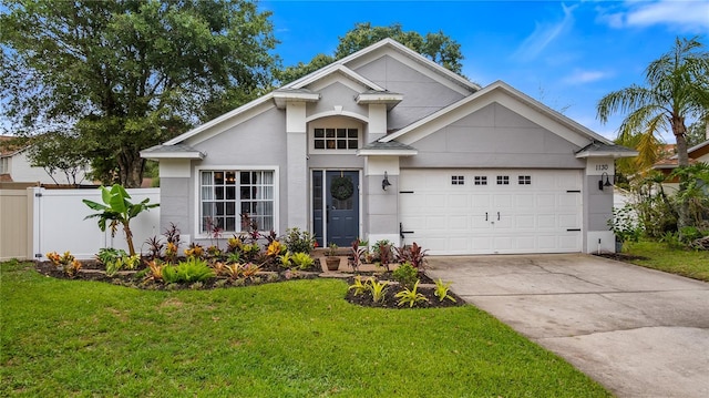 1130 Woodsong Way, Clermont, FL 34714 - view of front of property with driveway, a garage, and stucco siding