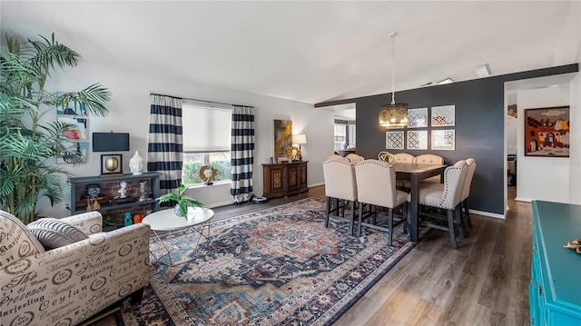 1130 Woodsong Way, Clermont, FL 34714 - dining area featuring wood finished floors, vaulted ceiling, and baseboards