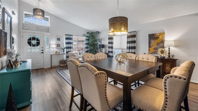 1130 Woodsong Way, Clermont, FL 34714 - dining room featuring a chandelier, wood finished floors, healthy amount of natural light, and high vaulted ceiling
