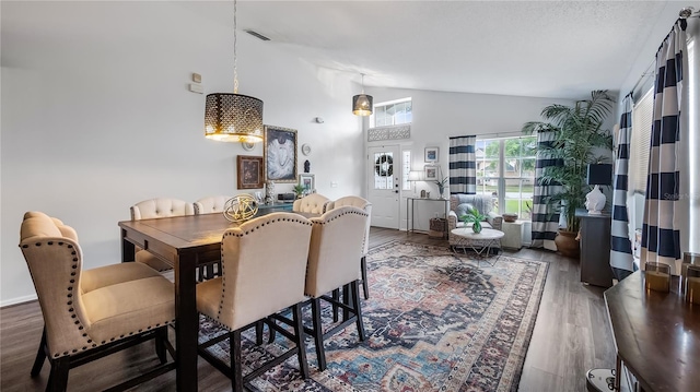 1130 Woodsong Way, Clermont, FL 34714 - dining area with vaulted ceiling, wood finished floors, and a chandelier